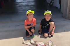 2 boys with fish